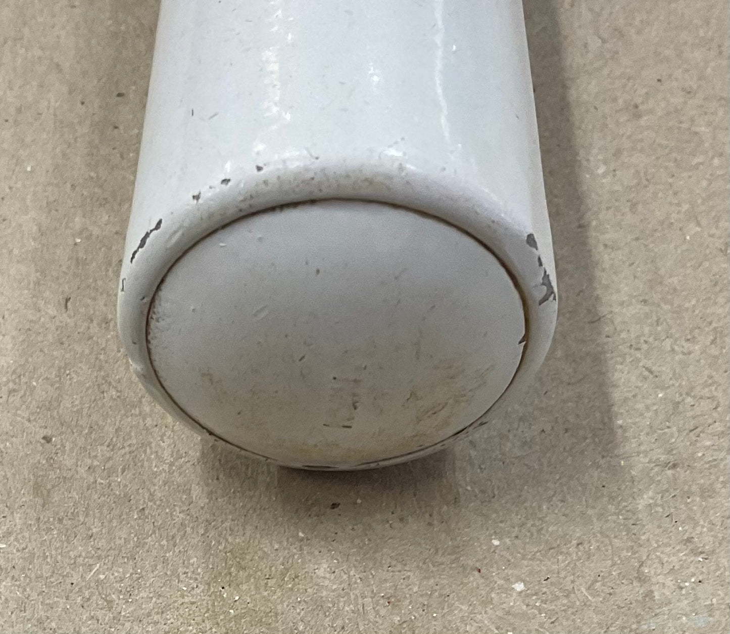 Vintage white enamel ice cream scoop with a tubular handle