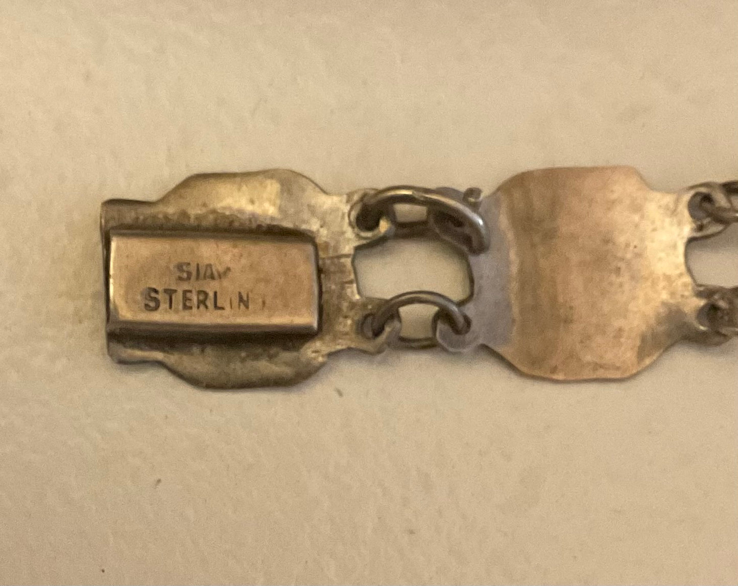 Vintage Siam Sterling silver bracelet featuring linked panels with traditional Niello enamel work.