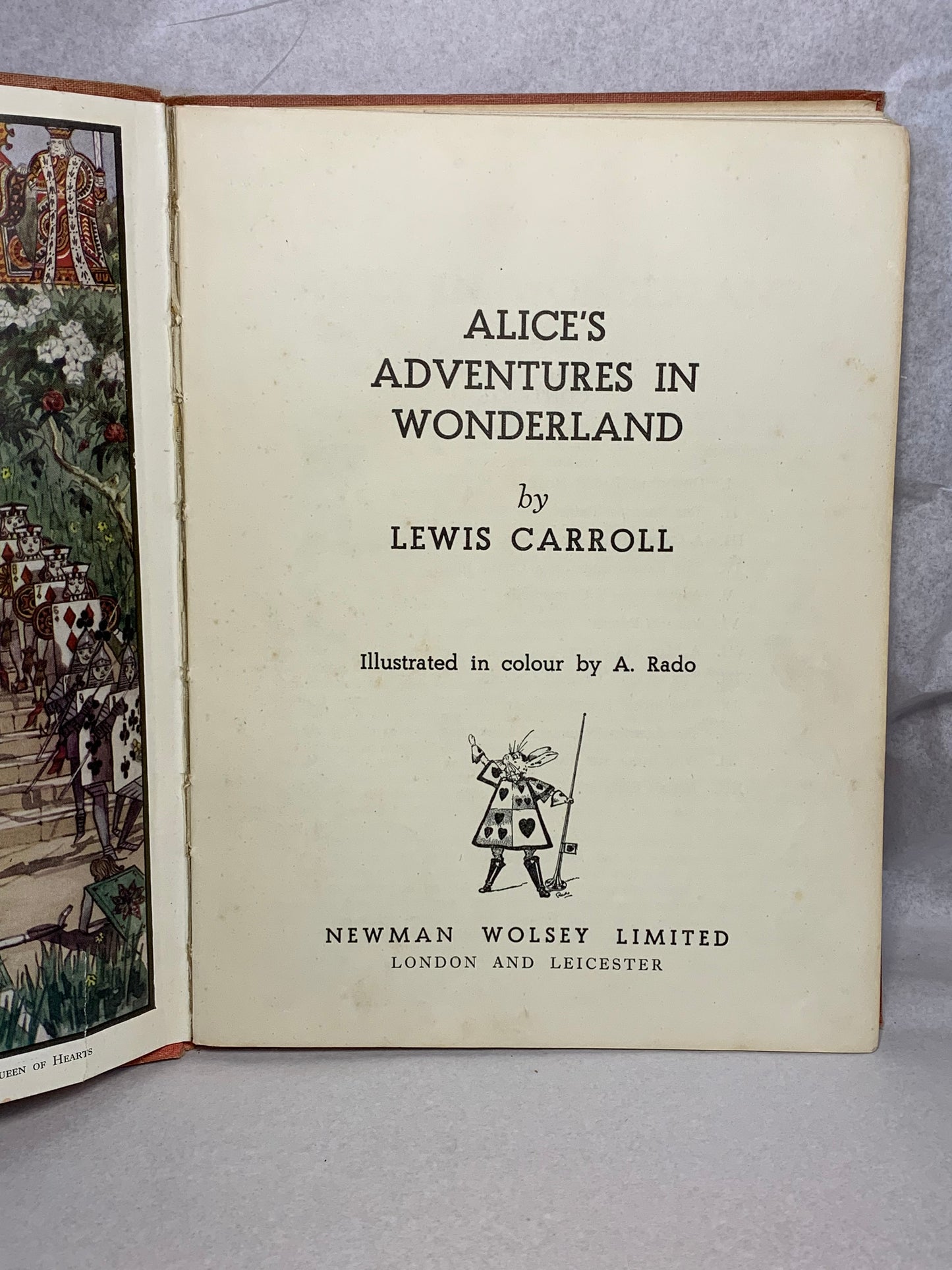 1944 first edition (thus) of Alice’s Adventures in Wonderland by Lewis Carroll, illustrated in colour by A. Rado, published by Newman Wolsey Limited, London and Leicester