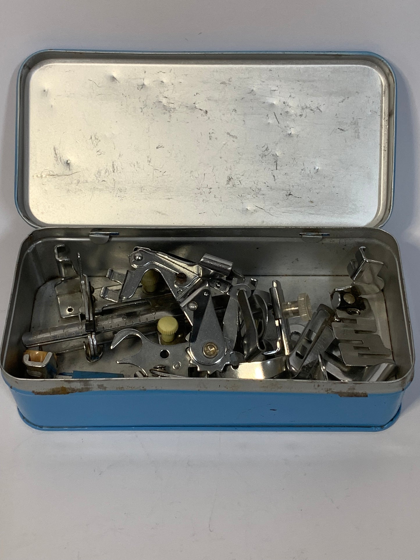 Vintage Sewing Machine Attachments Tin with attachments