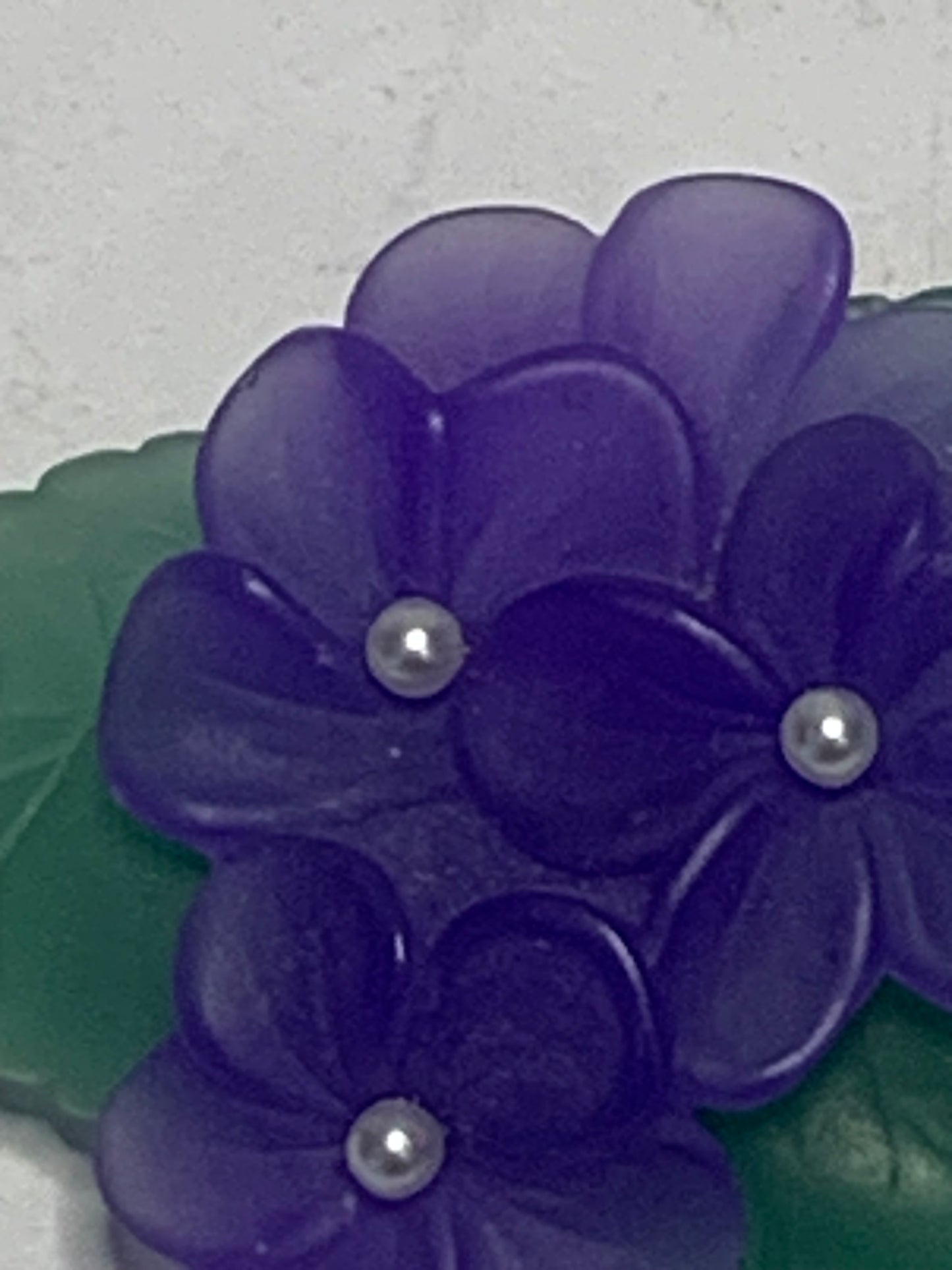 Vintage carved lucite African violet brooch from the 1980s-1990s featuring a charming floral spray design