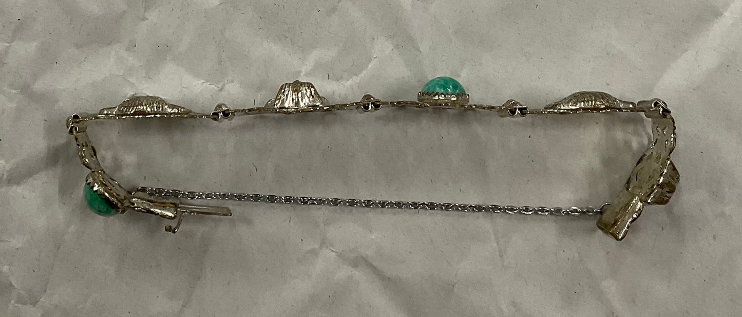 Vintage Egyptian Revival silver-tone filigree bracelet, featuring ornate Pharaoh and Sphinx motifs with raised relief detail