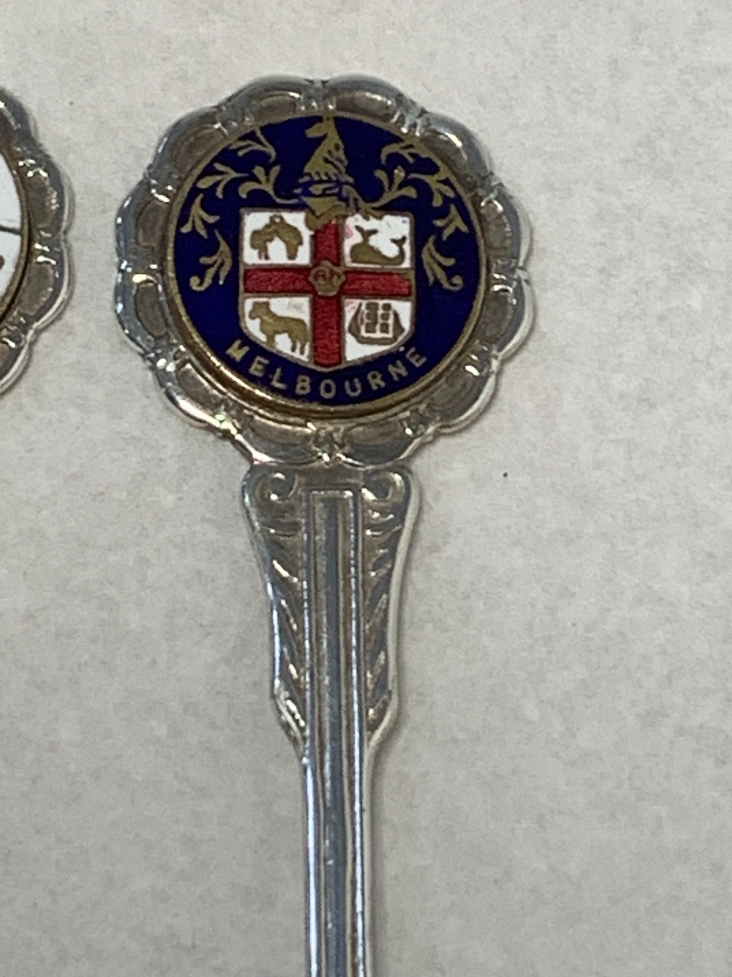 Set of six vintage silver-plated souvenir teaspoons featuring the enameled coats of arms of Australia’s state capital cities: Adelaide, Brisbane, Sydney, Perth, Hobart, and Melbourne