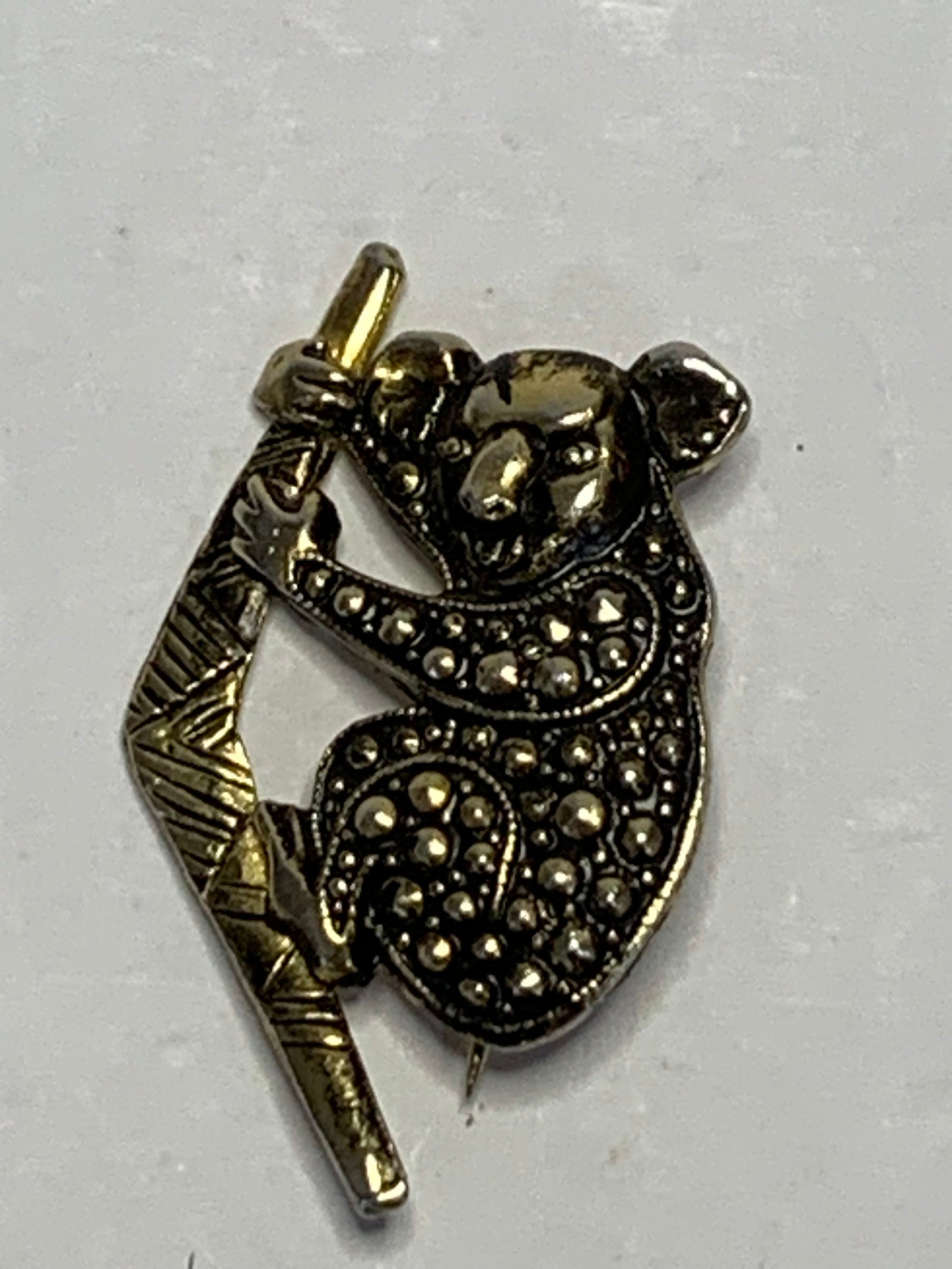 Vintage koala brooch featuring an iconic Australian design with a koala clinging to a boomerang