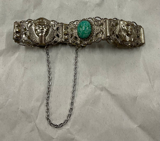 Vintage Egyptian Revival silver-tone filigree bracelet, featuring ornate Pharaoh and Sphinx motifs with raised relief detail