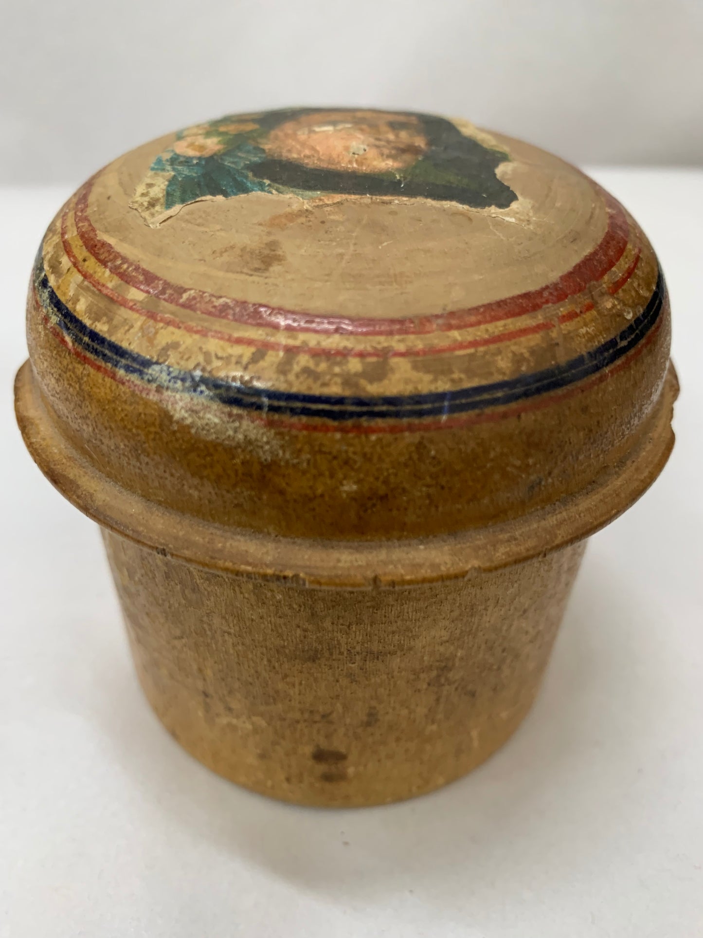 Antique turned wooden box with a painted religious icon on the lid, likely from the 19th or early 20th century.