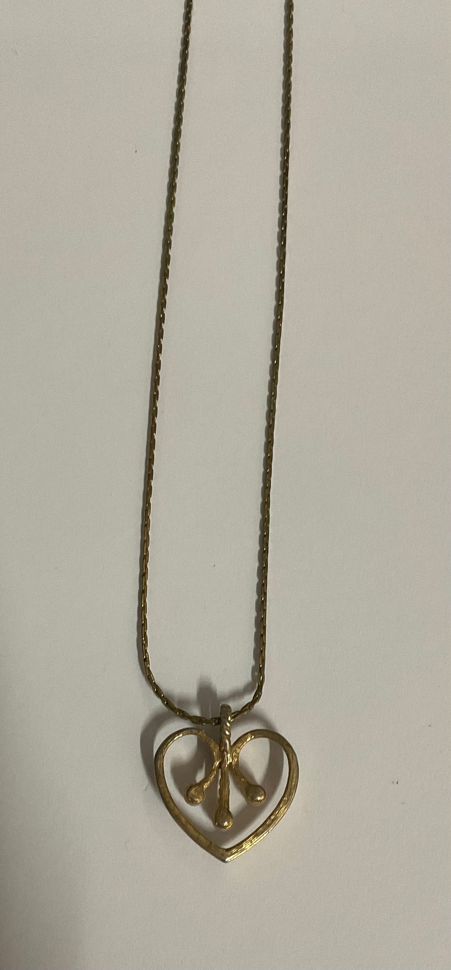 Vintage Avon necklace with a gold-tone chain and an open heart pendant.