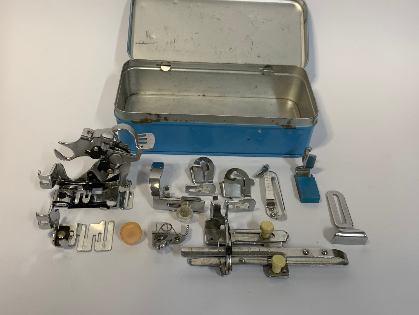 Vintage Sewing Machine Attachments Tin with attachments