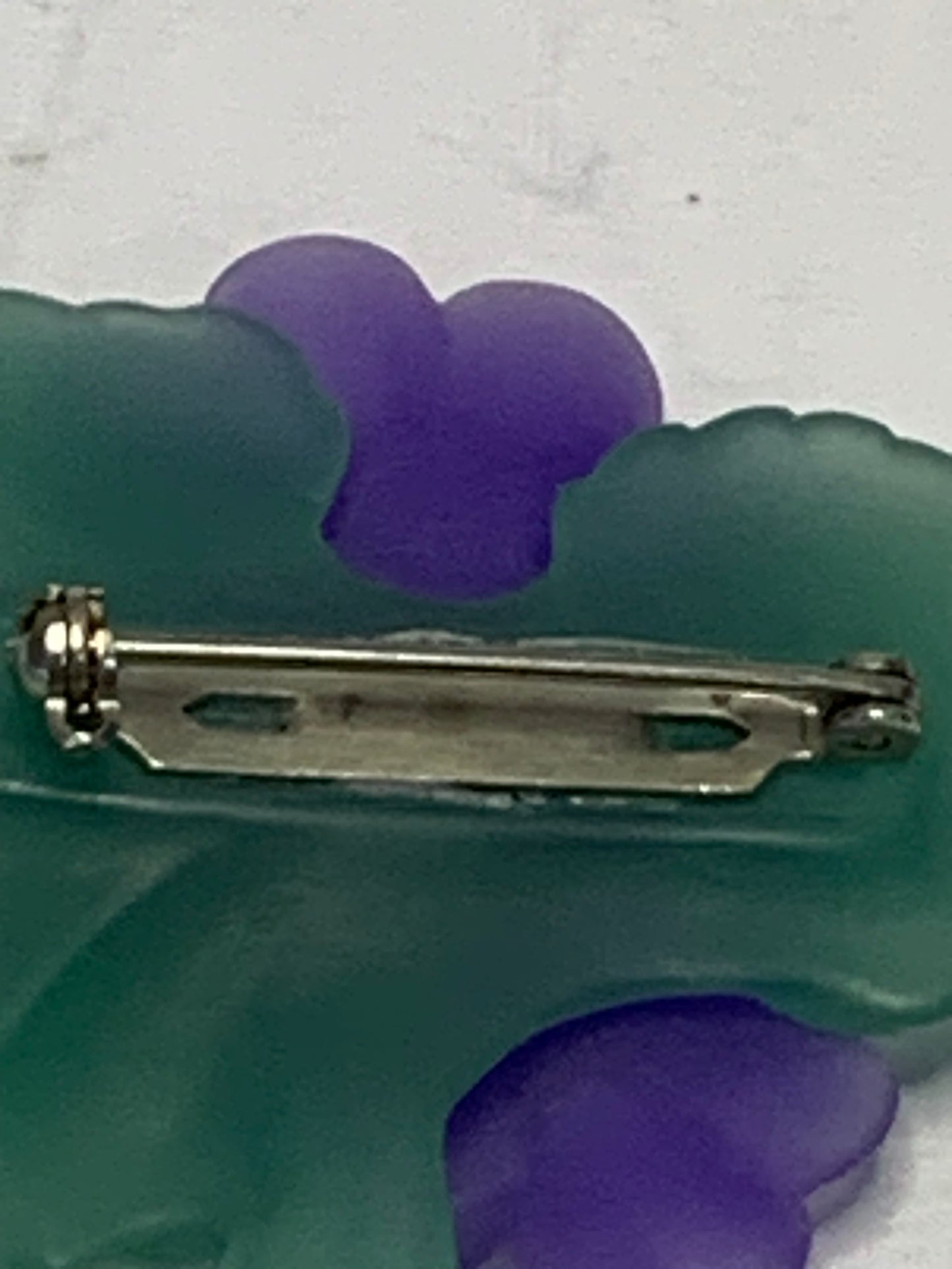 Vintage carved lucite African violet brooch from the 1980s-1990s featuring a charming floral spray design