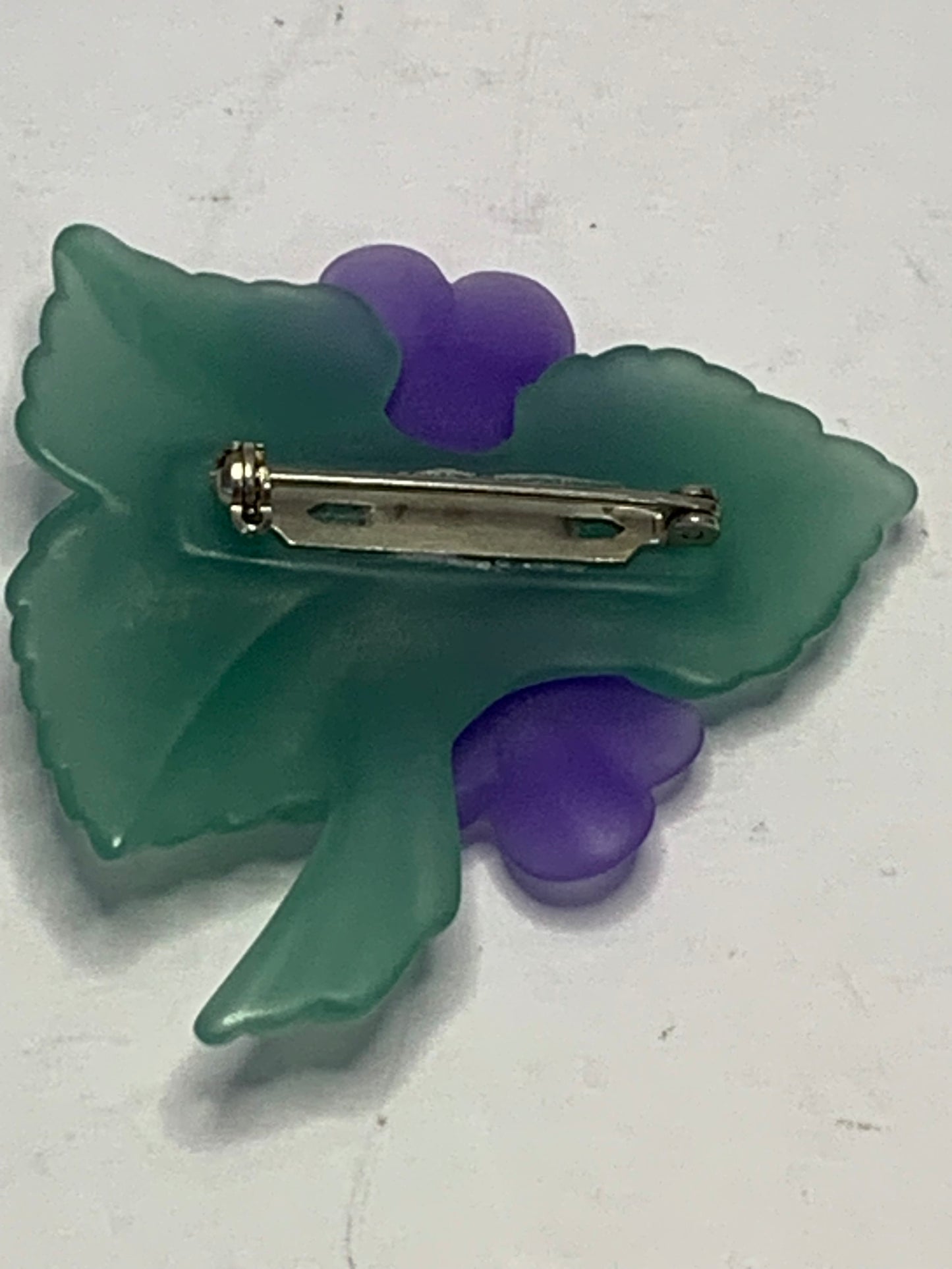 Vintage carved lucite African violet brooch from the 1980s-1990s featuring a charming floral spray design