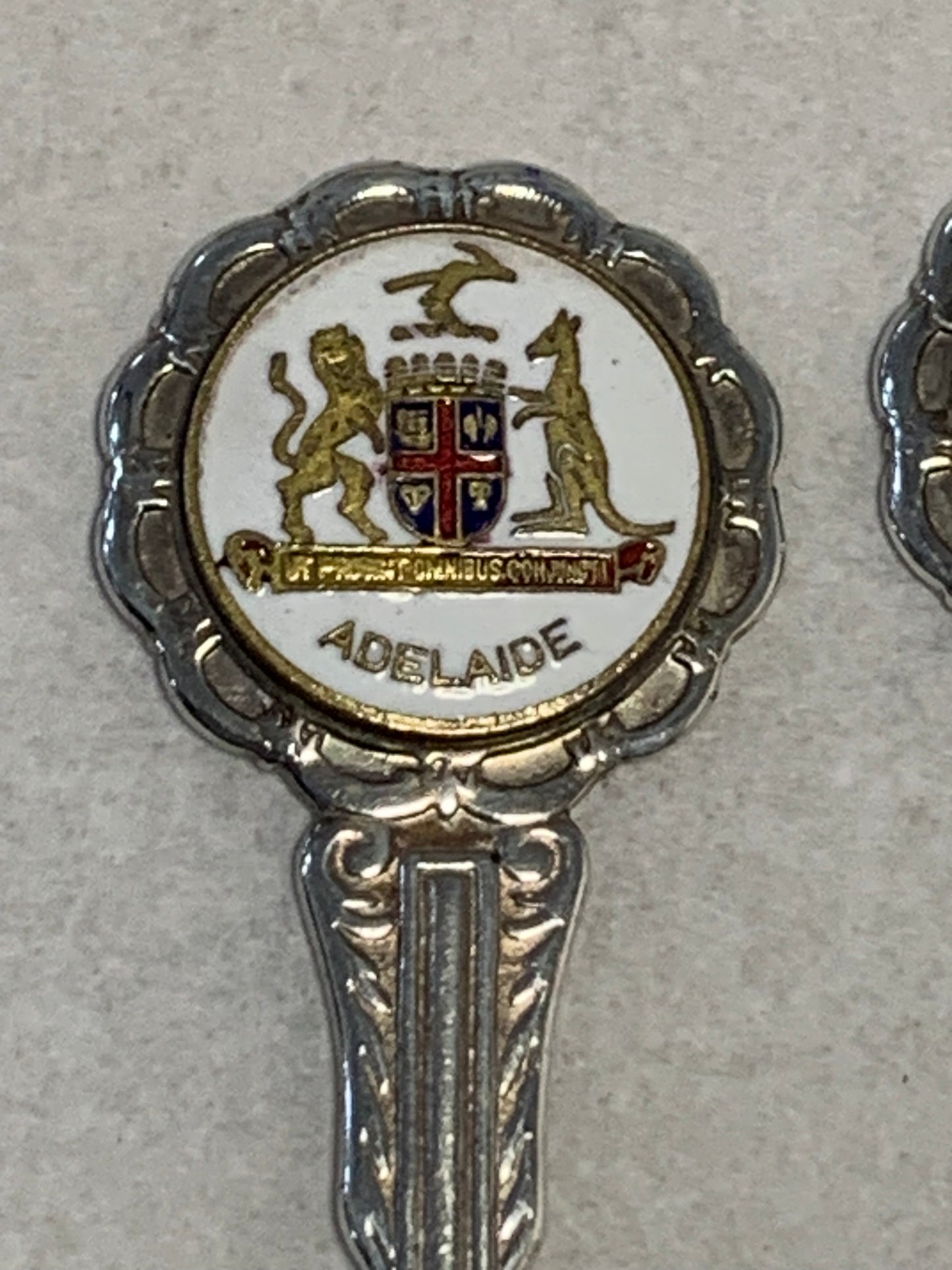 Set of six vintage silver-plated souvenir teaspoons featuring the enameled coats of arms of Australia’s state capital cities: Adelaide, Brisbane, Sydney, Perth, Hobart, and Melbourne