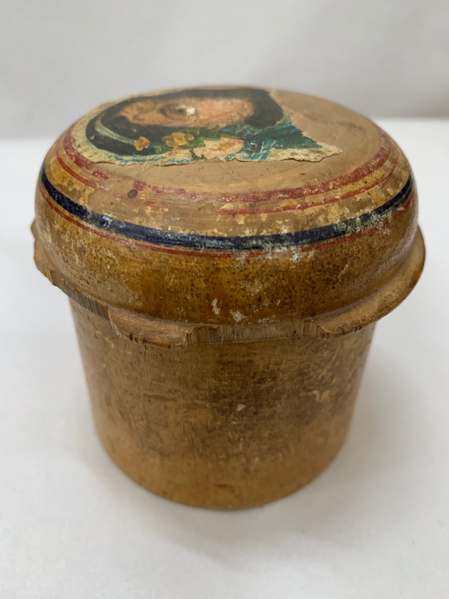 Antique turned wooden box with a painted religious icon on the lid, likely from the 19th or early 20th century.