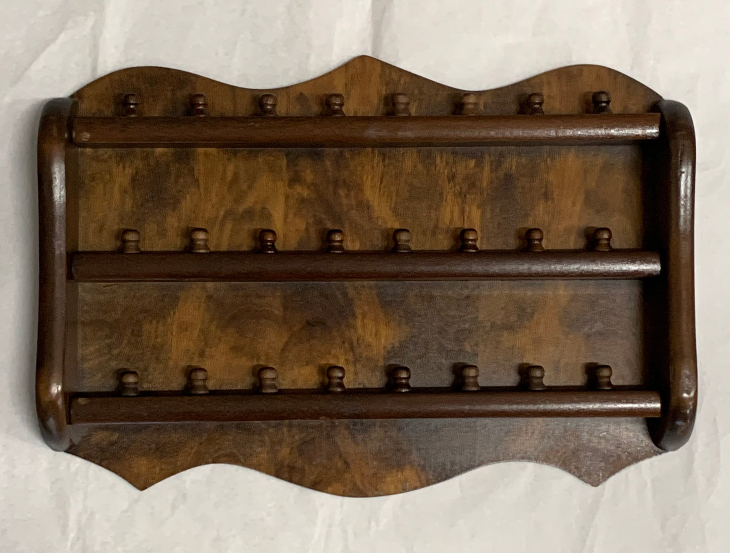 Vintage wooden wall-mounted thimble display rack, 1970s style, with a scalloped/shaped silhouette and rich mahogany-toned finish