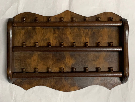 Vintage wooden wall-mounted thimble display rack, 1970s style, with a scalloped/shaped silhouette and rich mahogany-toned finish