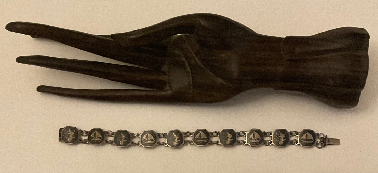 Vintage Siam Sterling silver bracelet featuring linked panels with traditional Niello enamel work.