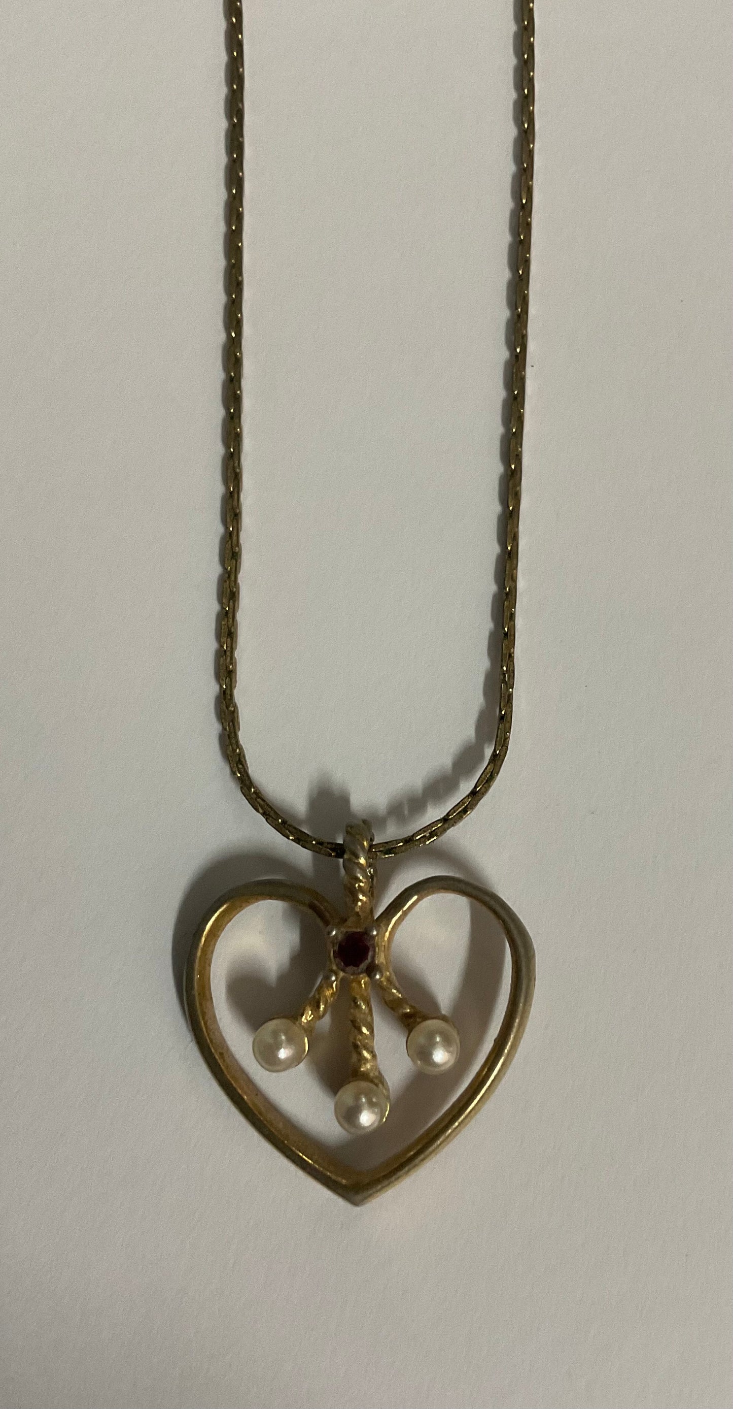 Vintage Avon necklace with a gold-tone chain and an open heart pendant.