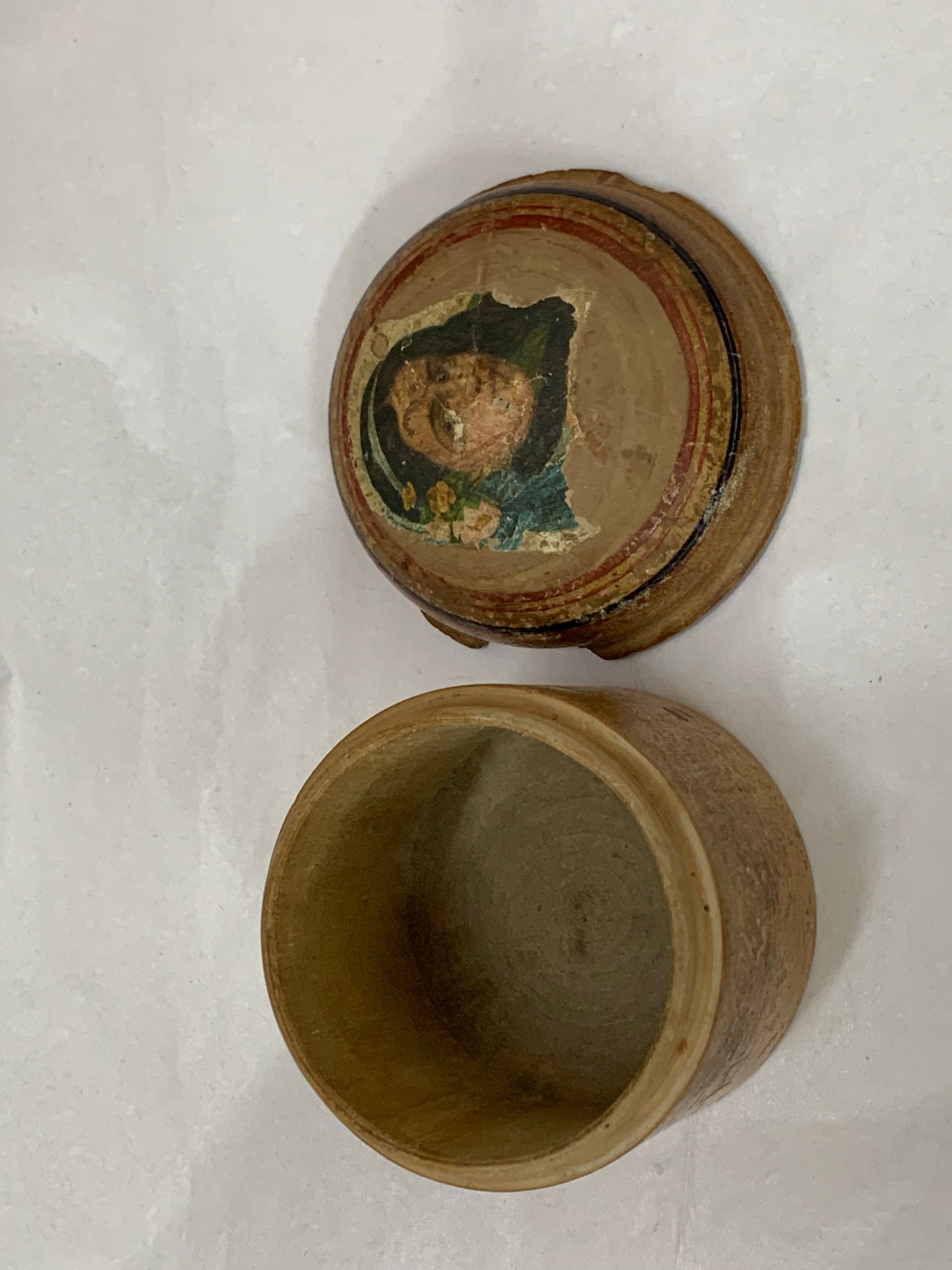 Antique turned wooden box with a painted religious icon on the lid, likely from the 19th or early 20th century.