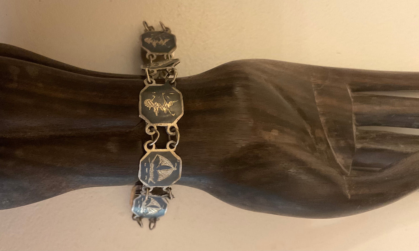 Vintage Siam Sterling silver bracelet featuring linked panels with traditional Niello enamel work.