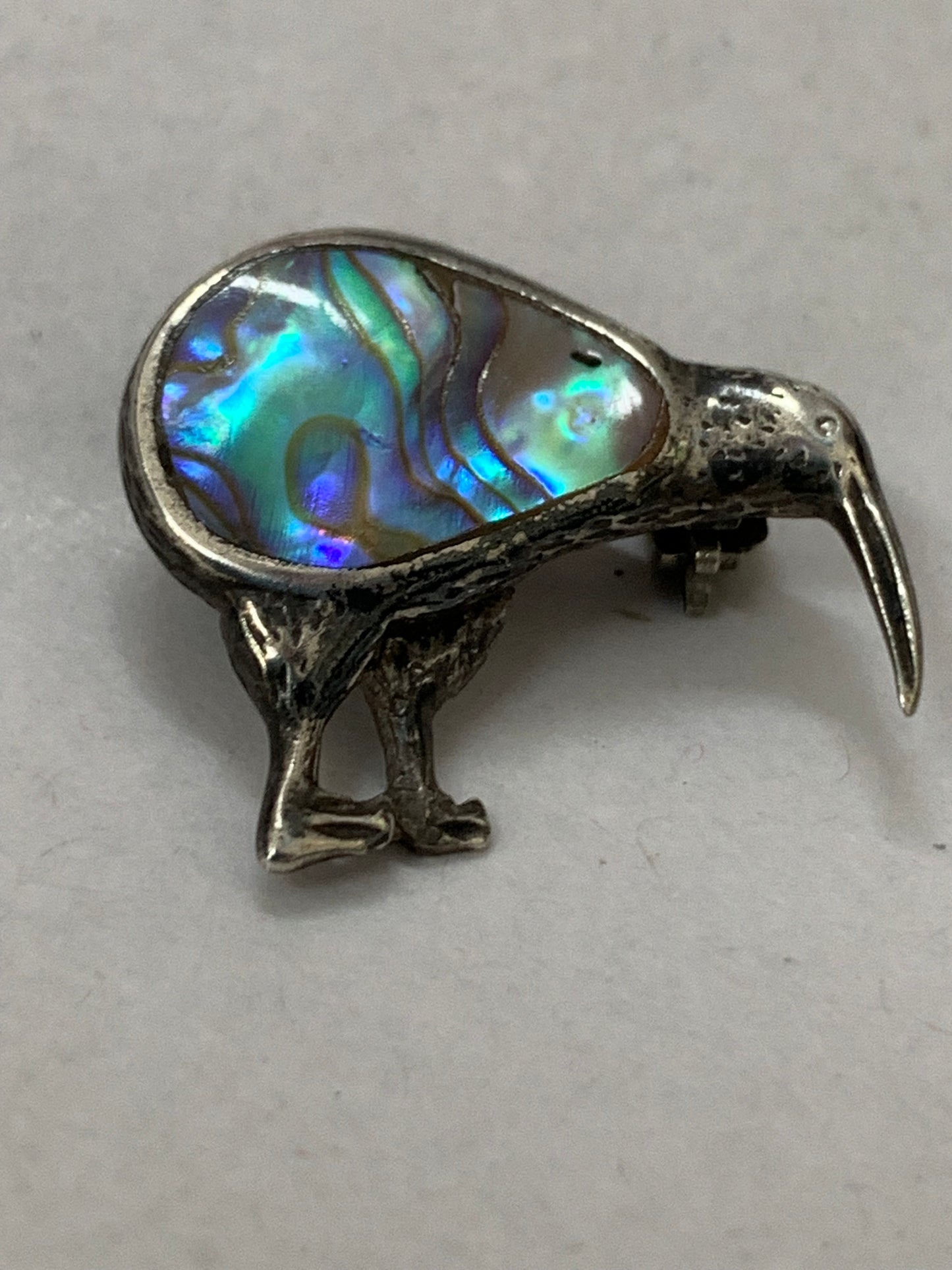 Vintage silver kiwi bird brooch with paua shell (abalone) inlay, likely from New Zealand, dating from approximately the 1960s-1980s.