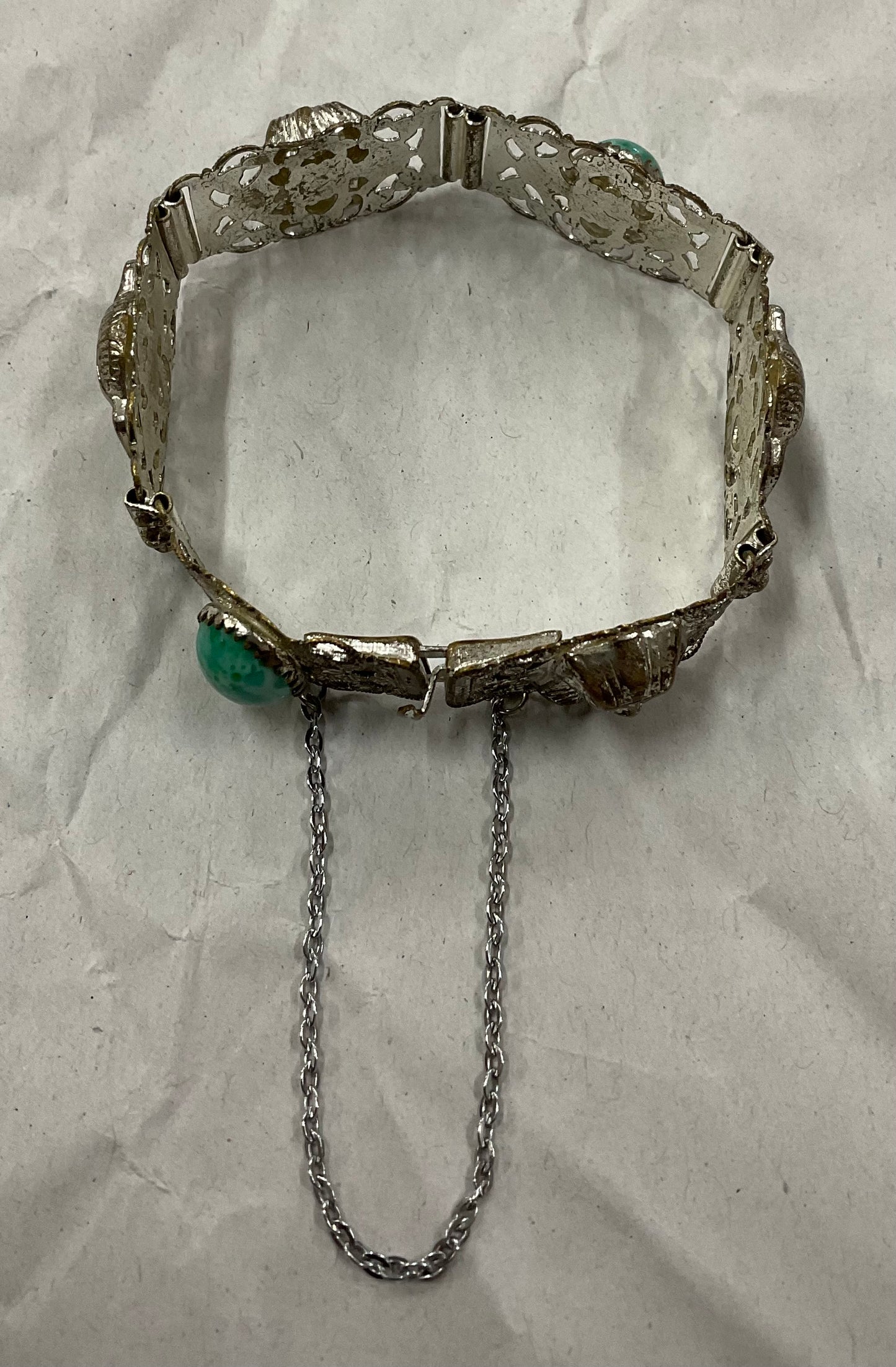 Vintage Egyptian Revival silver-tone filigree bracelet, featuring ornate Pharaoh and Sphinx motifs with raised relief detail