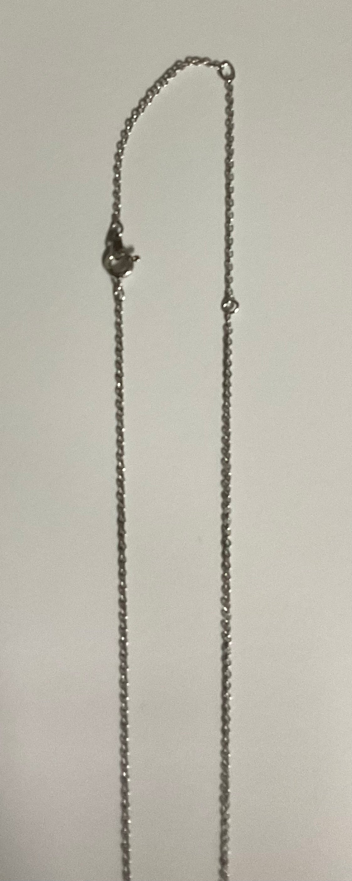 Vintage AVON modernist silver-tone pendant necklace featuring a sculptural tubular pendant with a reflective, wave-like design