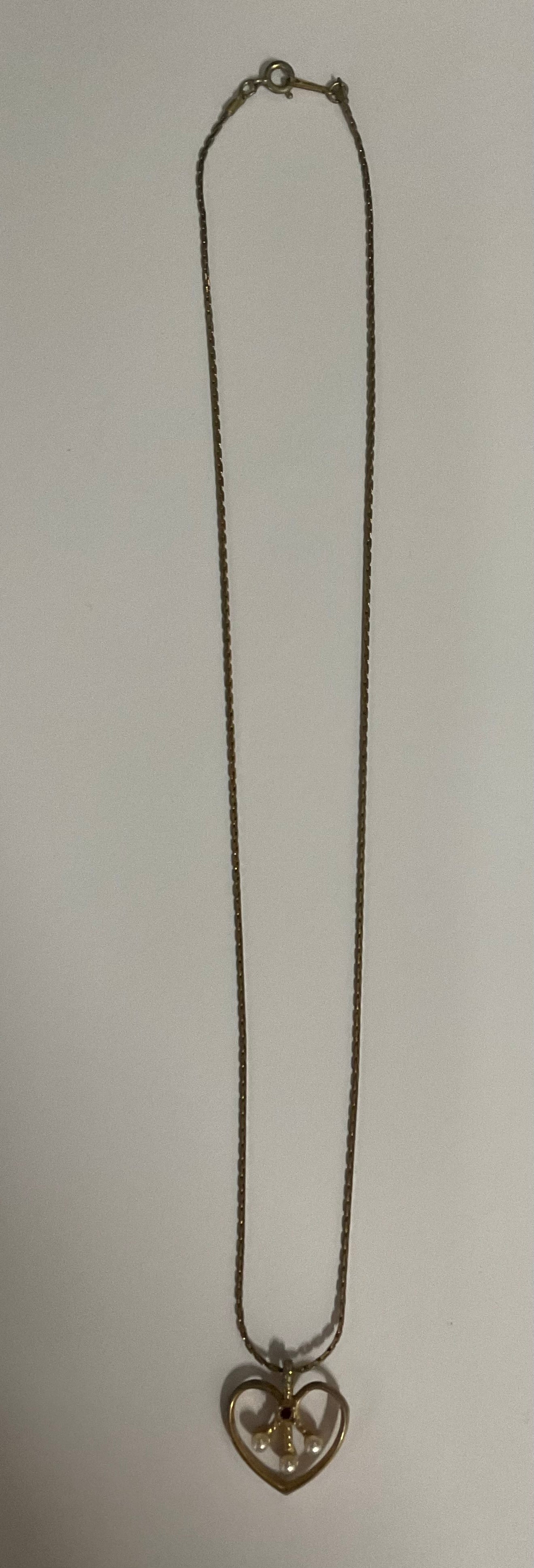 Vintage Avon necklace with a gold-tone chain and an open heart pendant.