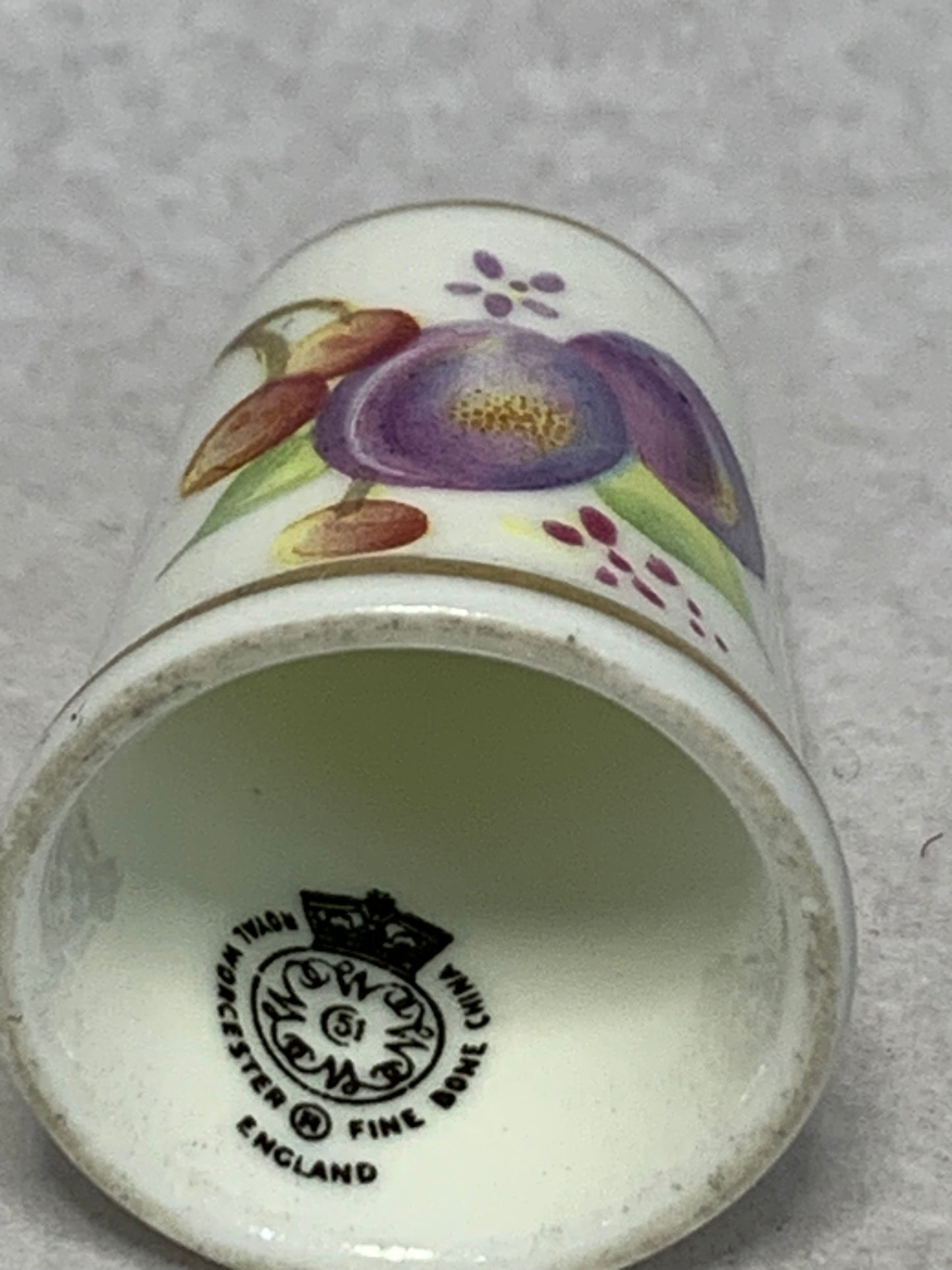 Pair of Royal Worcester fine bone china thimbles, hand-painted with fruit still-life designs (plums, cherries, apricots, and berries) on a white ground with gilt rims 1951