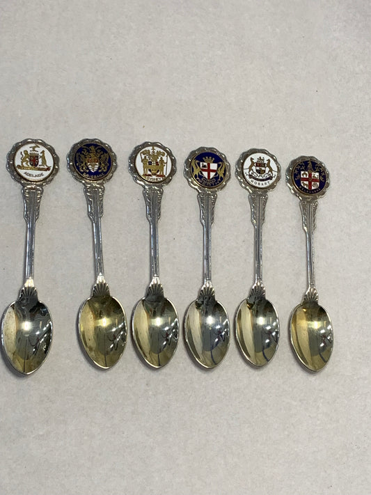 Set of six vintage silver-plated souvenir teaspoons featuring the enameled coats of arms of Australia’s state capital cities: Adelaide, Brisbane, Sydney, Perth, Hobart, and Melbourne
