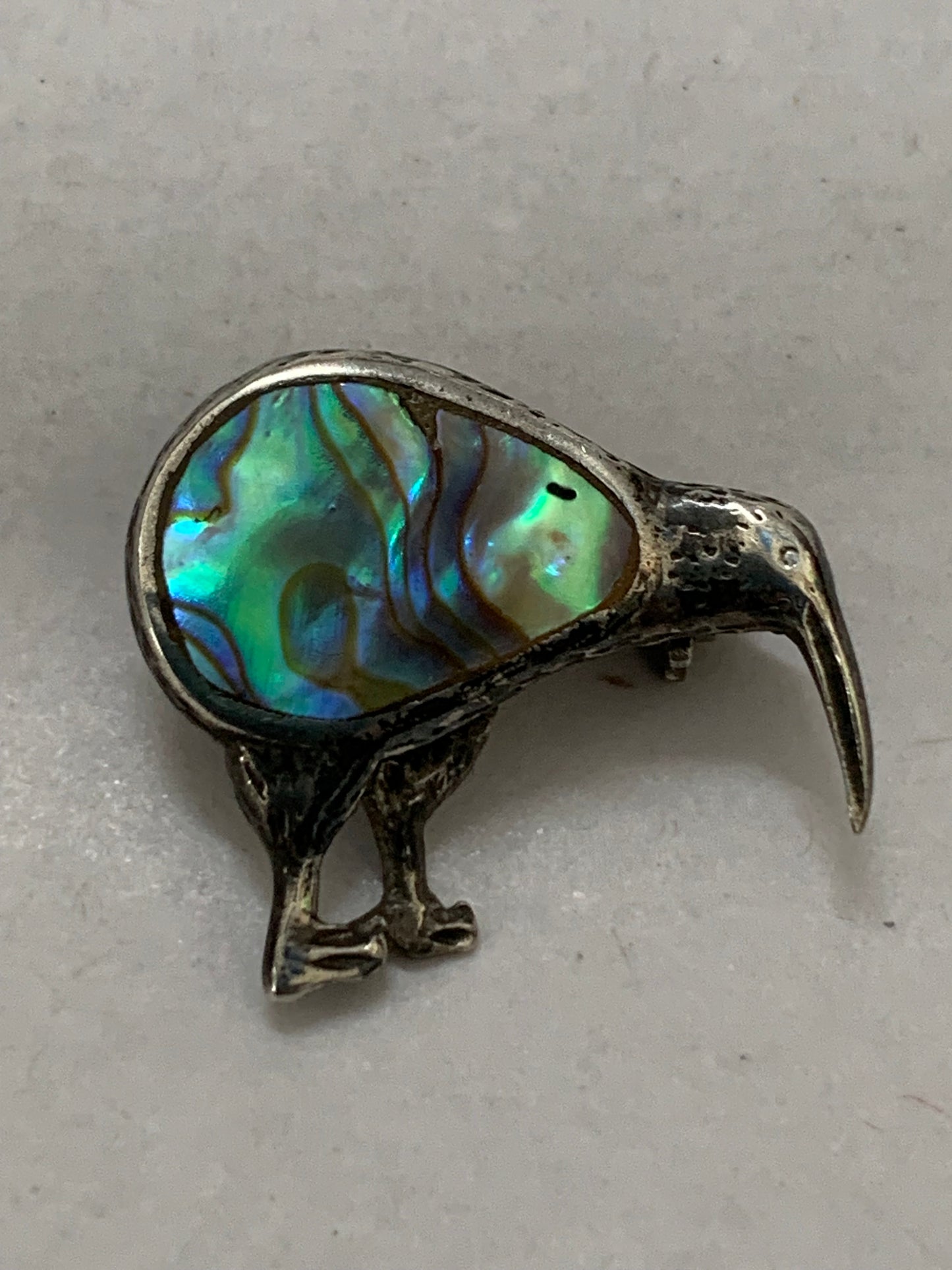 Vintage silver kiwi bird brooch with paua shell (abalone) inlay, likely from New Zealand, dating from approximately the 1960s-1980s.