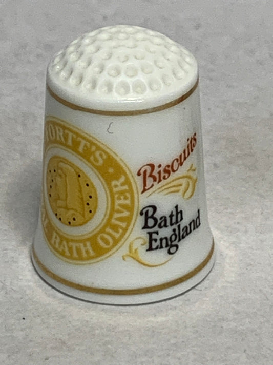 Pair of vintage 1982 “Fine Porcelain” (FP) golf-ball-top advertising thimbles, each featuring a nostalgic British brand:

	1.	Fortt’s Bath Oliver Biscuits — Bath, England
	2.	Brown & Polson (cornflour brand) — red shield logo with crown