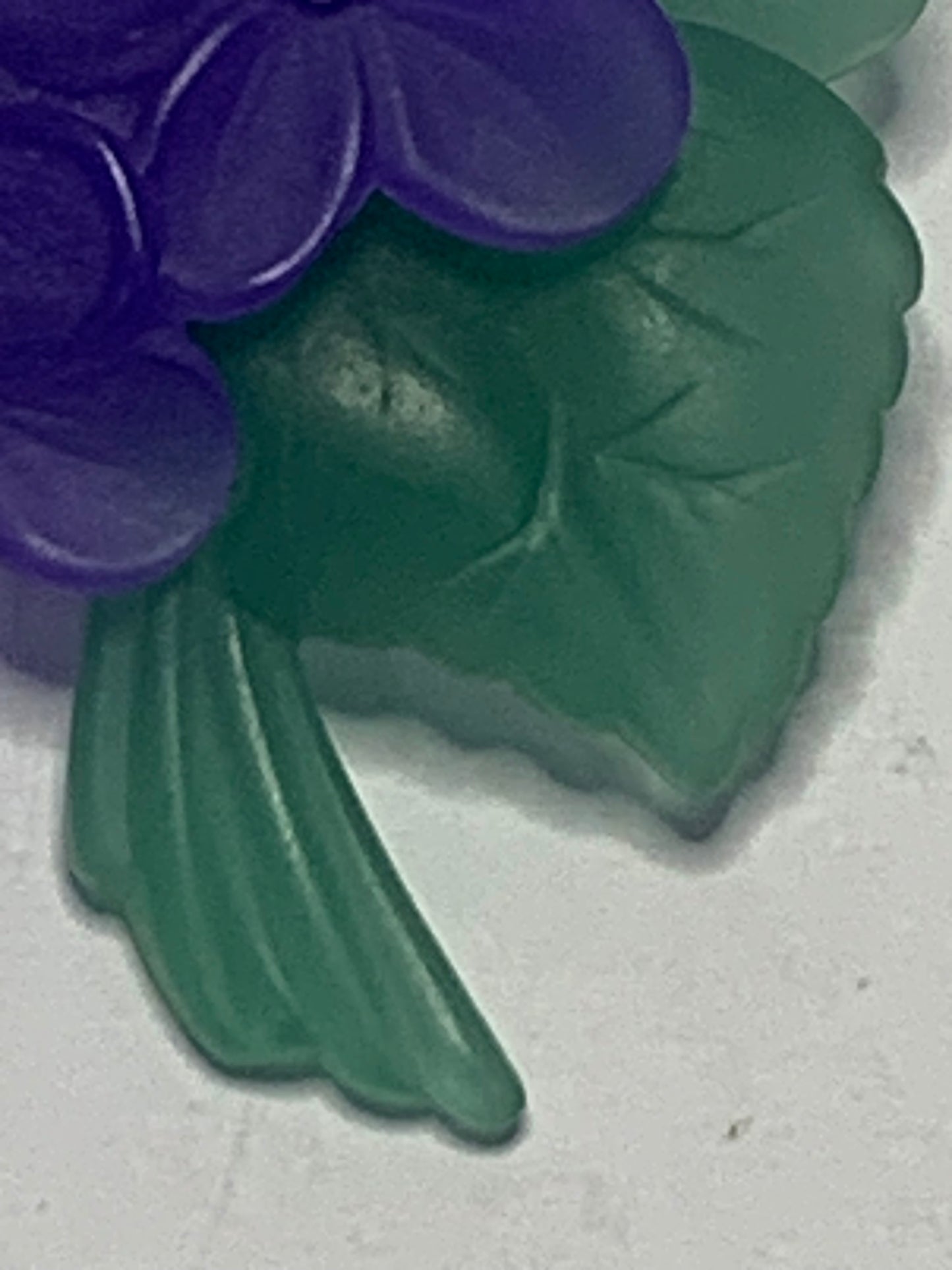 Vintage carved lucite African violet brooch from the 1980s-1990s featuring a charming floral spray design